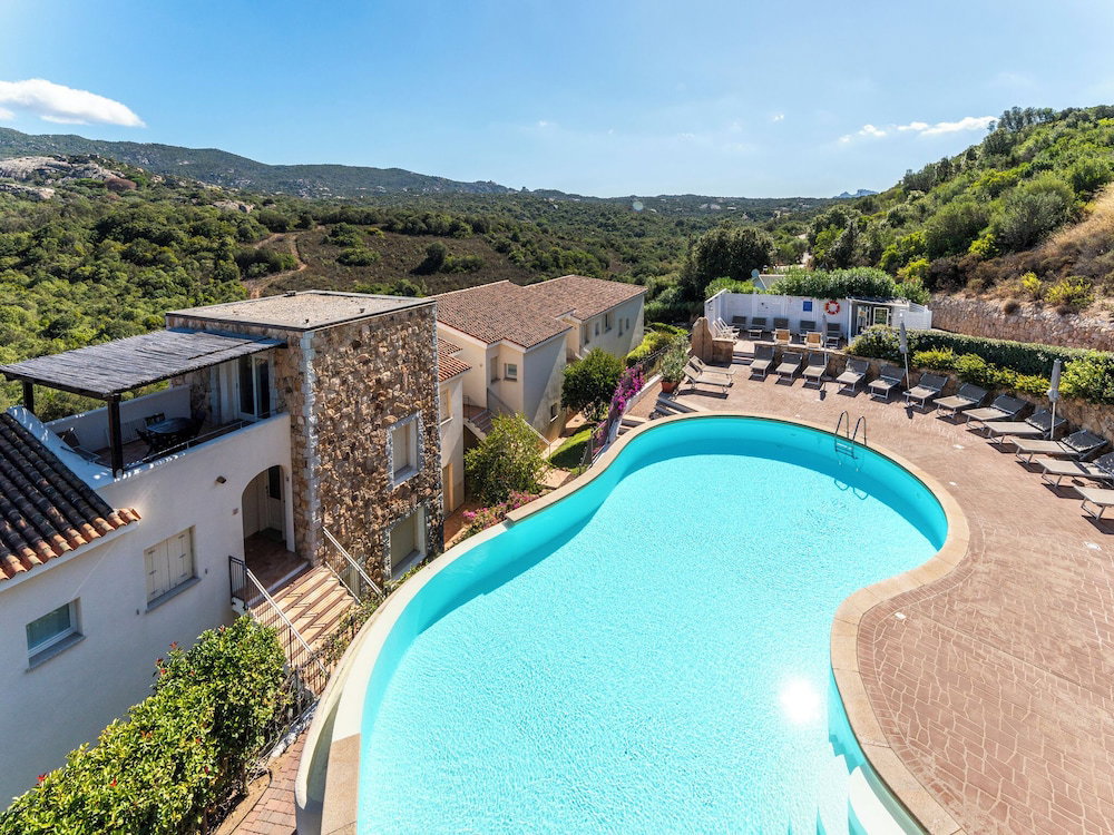 Hotel Complex Surrounded By Greenery With Pool